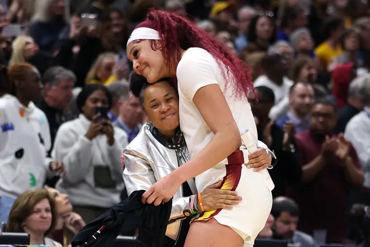 Dawn Staley and her star center Kamilla Cardoso embraced as South Carolina capped its championship game win over Caitlin Clark's Iowa.