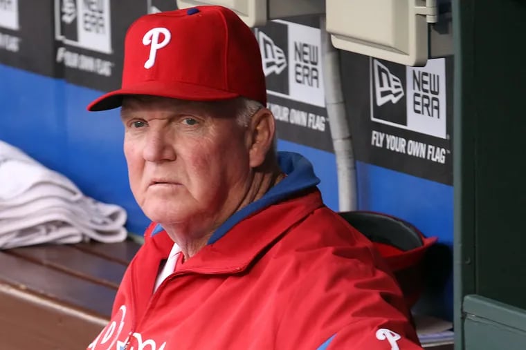 Charlie Manuel sitting in the Phillies' dugout as the team's manager in 2013.