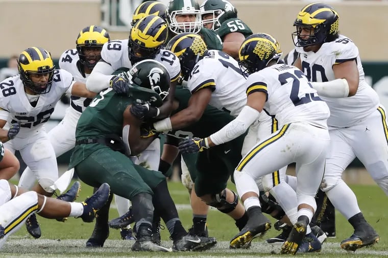 Michigan State running back LJ Scott is stopped by the Michigan defensive line during their game on  Oct. 20.