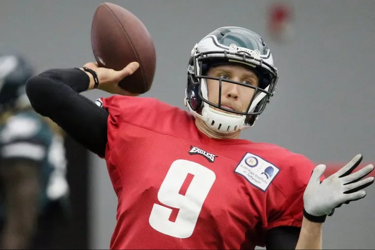 Quarterback Nick Foles throws a pass during Eagles practice at the NovaCare Complex on Thursday, Jan. 25. So far, Super Bowl bettors like the Eagles.