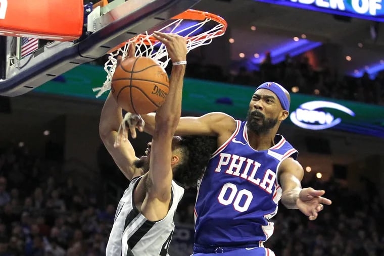 Corey Brewer, right, of the Sixers comes from behind to block a shot by  Derrick White of the Spurs in the 2nd quarter on Jan. 23, 2019. Brewer was called for a foul.