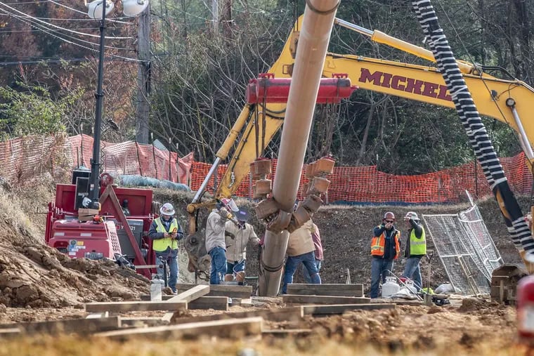Workers install a segment of the Mariner East pipeline in Chester County in November prior to it being pulled underground.