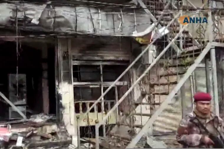 This frame grab from video provided by Hawar news, the news agency for the semi-autonomous Kurdish areas in Syria (ANHA), shows the damaged restaurant where explosion occurred near a patrol of the U.S.-led coalition, in Manbij town, Syria, Wednesday, Jan. 16, 2019.