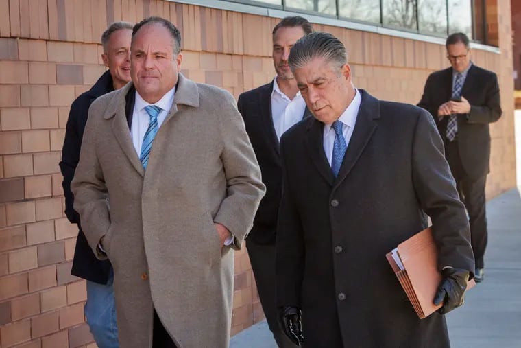 Ex-Local 98 apprentice training director Michael Neill leaves the federal courthouse in Reading with his attorney Joseph P. Capone, right, after he was sentenced Tuesday for embezzling, along with others, more than $600,000 from the union.