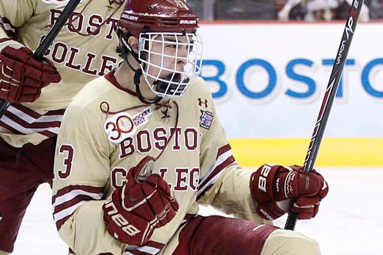 Boston College's Johnny Gaudreau, right, celebrates his goal with teammate Bill Arnold, left, during the first period of an NCAA men's college hockey Frozen Four tournament game against Union, Thursday, April 10, 2014, in Philadelphia. (Chris Szagola/AP)