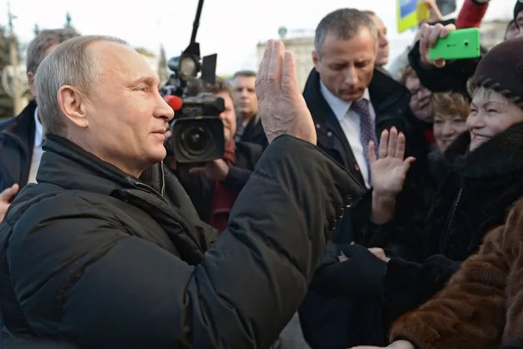Russian President Vladimir Putin greets residents of Nizhny Tagil in the Ural Mountains. He has promised not to send ground troops to aid Syria's regime.