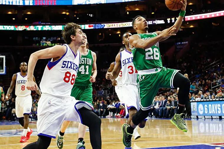 Boston Celtics guard Phil Pressey (26) goes up for a layup past Philadelphia 76ers guard Alexey Shved (88) during the second half at Wells Fargo Center. The Celtics defeated the 76ers 105-87. (Bill Streicher/USA Today)