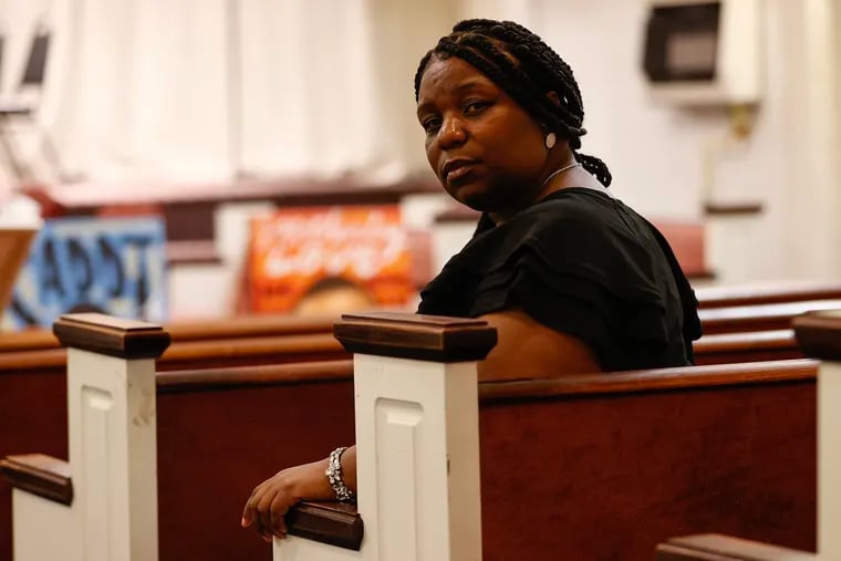 Andrea Robinson sits inside the United Church of the First Born in North Philadelphia before the start of an anti-violence event on May 27.