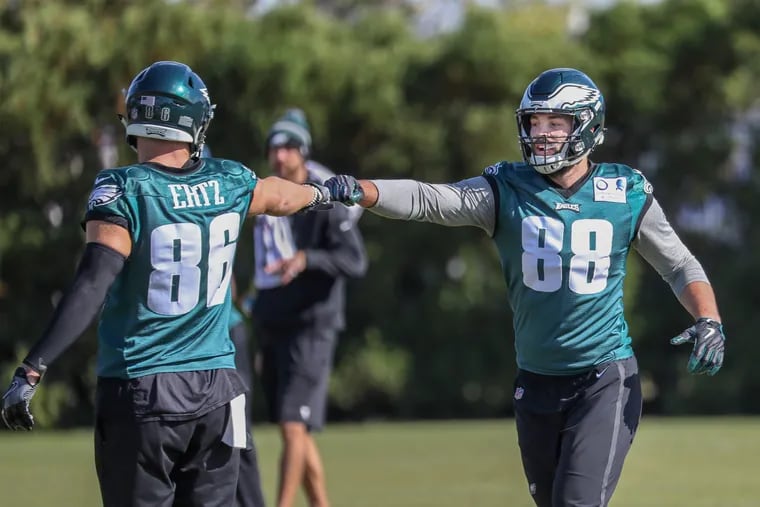 Eagles tight ends Zach Ertz (left) and Dallas Goedert, exchange fist bumps during practice in 2018.

,