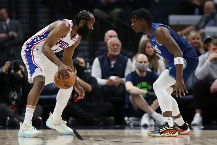 James Harden, in his Sixers debut, stares down Minnesota's Anthony Edwards during the first half of Friday night's game in Minnesota. Harden finished the night with 27 points, eight rebounds, and 12 assists.