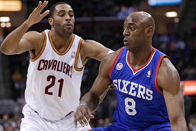 Philadelphia 76ers' Damien Wilkins (8) drives past Cleveland Cavaliers' Wayne Ellington (21) during the first quarter of an NBA basketball game Friday, March 29, 2013, in Cleveland. (AP Photo/Tony Dejak)