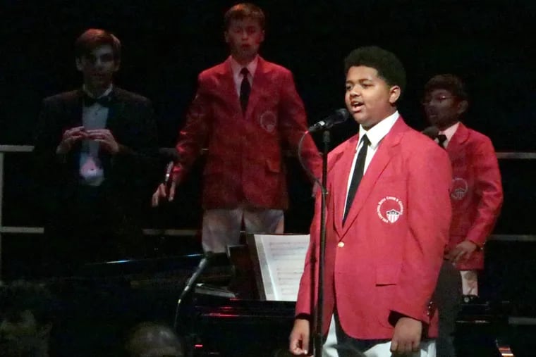 Nash McBride (center right) is a baritone in the Philadelphia Boys Choir & Chorale. The choir will perform at Verizon Hall on Sunday, in a program written largely by Nash’s father, the writer and musician James McBride.