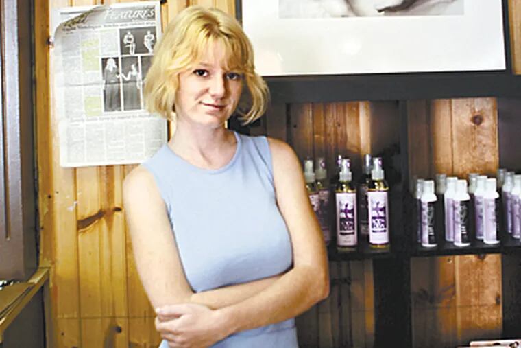 Jill McDevitt, owner of the Feminique Botique in her Shop in West Chester. (Bonnie Weller / Inquirer)