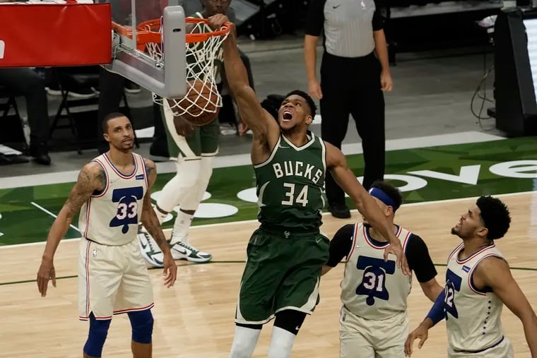 The Bucks' Giannis Antetokounmpo dunks during the second half against the 76ers.