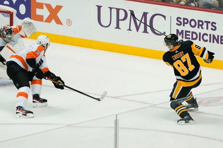 The  Penguins' Sidney Crosby scores his 500th NHL career goal on Flyers goaltender Carter Hart during the first period.