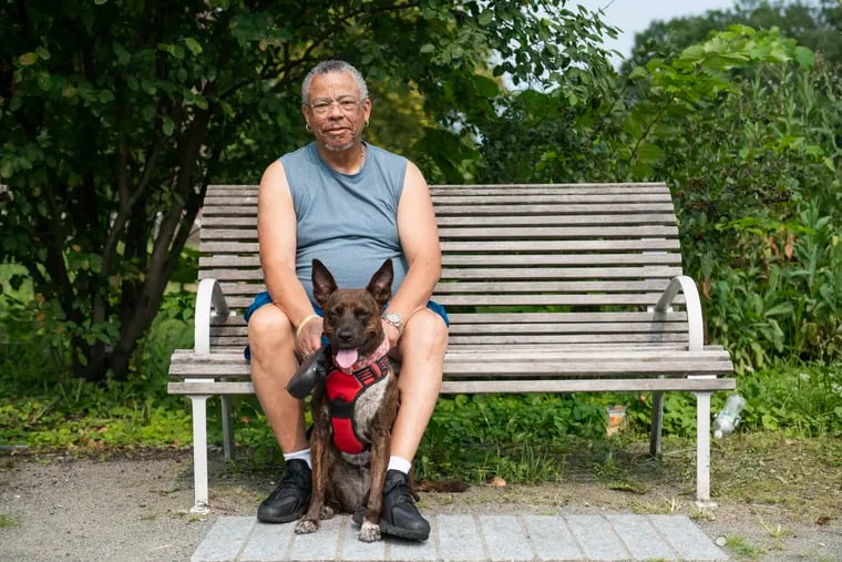 Santos Lopez with his dog, Kandi, in Fairmount Park.