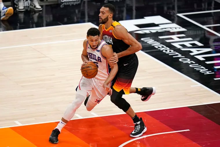 Utah Jazz center Rudy Gobert, right, defends against Philadelphia 76ers guard Ben Simmons, left, in the first half during an NBA basketball game Monday, Feb. 15, 2021, in Salt Lake City. (AP Photo/Rick Bowmer)
