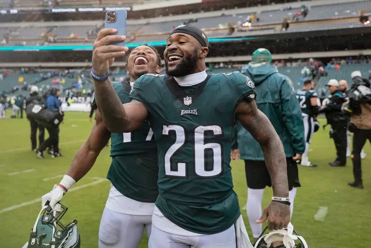 Eagles running backs Miles Sanders (26) and Kenneth Gainwell taking a selfie after beating the Jaguars at the Linc on Sunday.