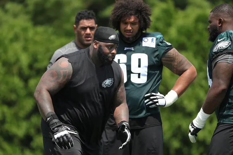 Eagles' Jason Peters, left, takes time to work with teammates after the first session of the Philadelphia Eagles training camp at the Novacare Complex on July 26, 2018 in Philadelphia, PA. DAVID MAIALETTI / Staff Photographer
