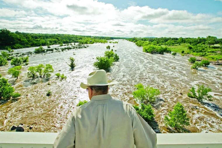 After another round of heavy rains, Tex Toler watches the river rise in Llano, Texas. Thunderstorms stalled over Dallas, dumping seven inches of rain overnight into Friday.