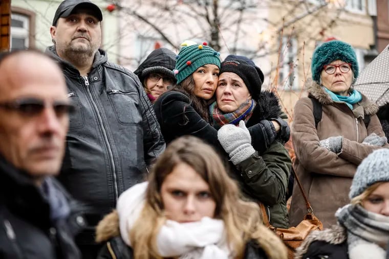 Residents react during a gathering being held in a central square of the eastern French city of Strasbourg, Sunday Dec.16, 2018 to pay homage to the victims of a gunman who killed four people and wounded a dozen more. The gathering was held in Kleber Square by a Christmas market and near where the gunman opened fire last Tuesday evening. (AP Photo/Jean-Francois Badias)
