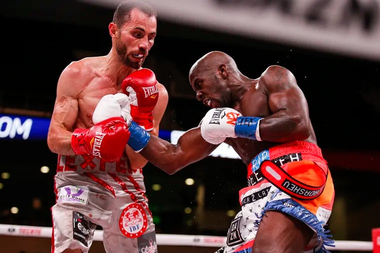 Tevin Farmer, right, lands a punch on Guillaume Frenois in the fifth round of a boxing match, Saturday, July 27, 2019, in Arlington, Texas. Farmer won the 12-round match.