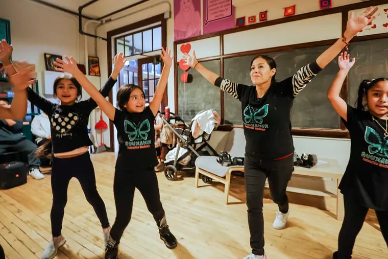 Instructor Andrea Garcia (right), leads a dance during a Folklorico Nuuxakun class at the Bok Building in South Philadelphia. The class helps children learn about Mexican traditions and feel comfortable being bilingual.