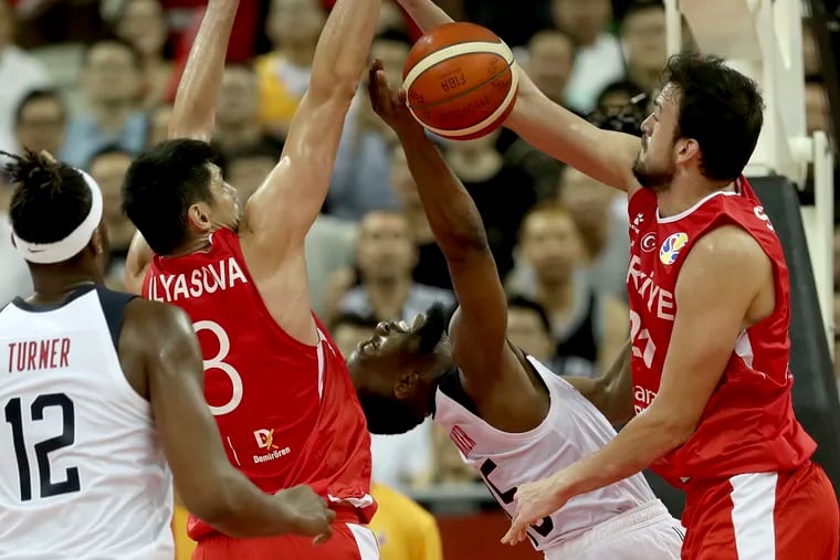 United States' Kemba Walker is blocked by Turkey's Ersan Ilyasova, second from left and Turkey's Sertac Sanli at right during a Group E match for the FIBA Basketball World Cup at the Shanghai Oriental Sports Center in Shanghai on Tuesday, Sept. 3, 2019. The United States beat Turkey 93:92.(AP Photo/Ng Han Guan)