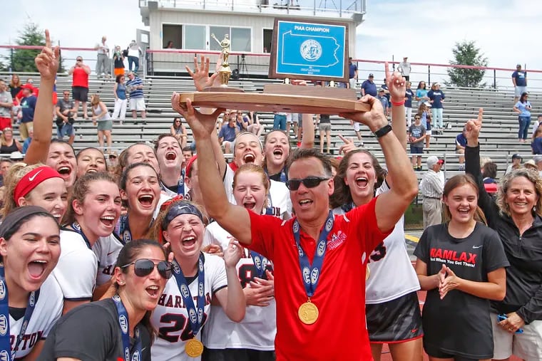 Harriton coach George Dick holds up the trophy after the Rams won the PIAA Class 3A lacrosse championship Saturday, June 8, 2019, at West Chester East. The Rams defeated Manheim Township in the final, 12-6.