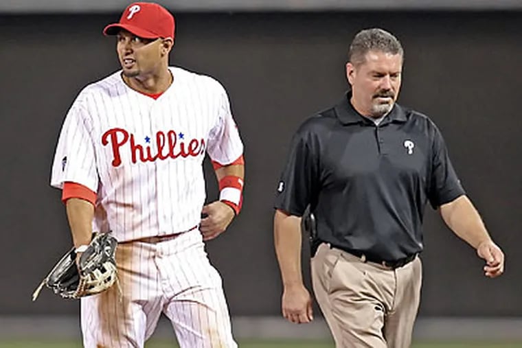 Shane Victorino left the field with trainer Mark Anderson after suffering an injury during the seventh inning. (Steven M. Falk/Staff Photographer)
