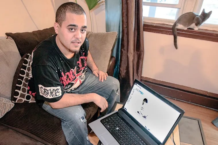 Angel Rodriguez, 22, a student in the Career Online High School program at his Camden, N.J., home, Friday, Dec. 26, 2014. (STEVEN M. FALK/Staff Photographer)