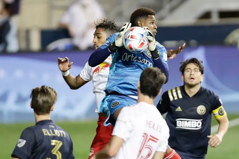 Union goalkeeper Andre Blake catches the soccer past Red Bulls forward Fabio.