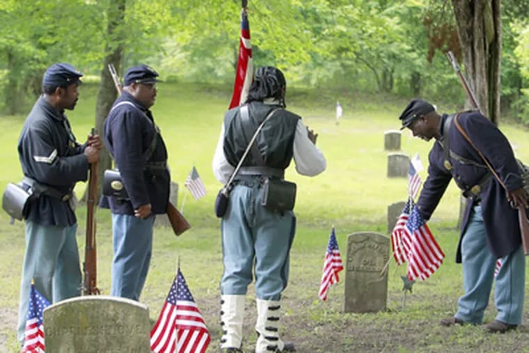 Reenactors of the Sixth Regiment United States Colored Troops pay tribute to African American Civil War veterans buried in the cemetery of the tiny village of Timbuctoo in Westampton Twp., Burlington County. (Akira Suwa / Staff Photographer)