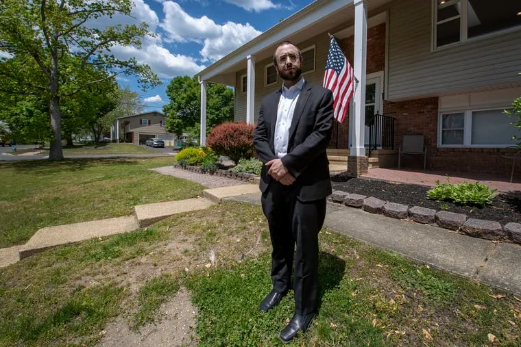 Mordechai Burnstein, a Jackson, N.J. resident and a leader of its Orthodox Jewish community, stands outside his home.