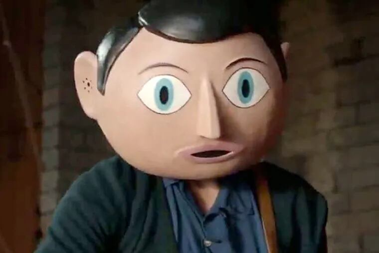 Michael Fassbender- his chiseled mug encased in a cartoonish papier-mâché head- as the title character, the nutty front man for a rock band, in Frank.