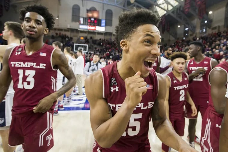 Nate Pierre-Louis, center, of Temple celebrates as they go off the court after their 60-51 victory over Penn at the Palestra on Jan 20, 2018.