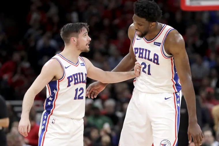 Sixers guard T.J. McConnell and Joel Embiid during the first half of the Sixers’ win over the Bulls on Thursday.