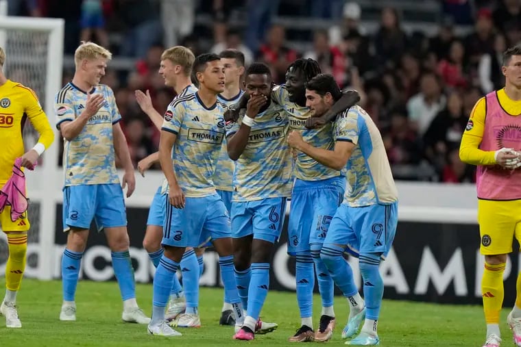 Union players celebrate after the final whistle of their 2-2 tie at Mexico's Atlas that clinched qualification for the Concacaf Champions League semifinals.