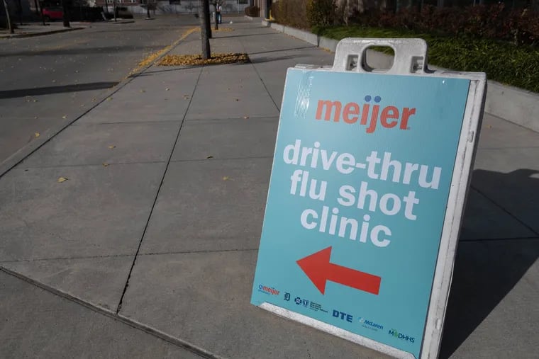 A sign directing traffic to a drive-through flu shot station is pictured at Comerica Park in downtown Detroit.