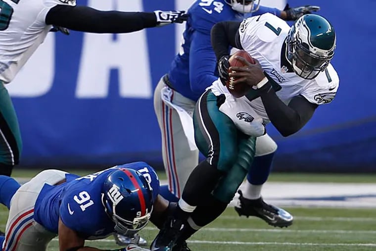 The Eagles' Michael Vick is sacked by Giants Justin Tuck (Ron Cortes/Staff Photographer)