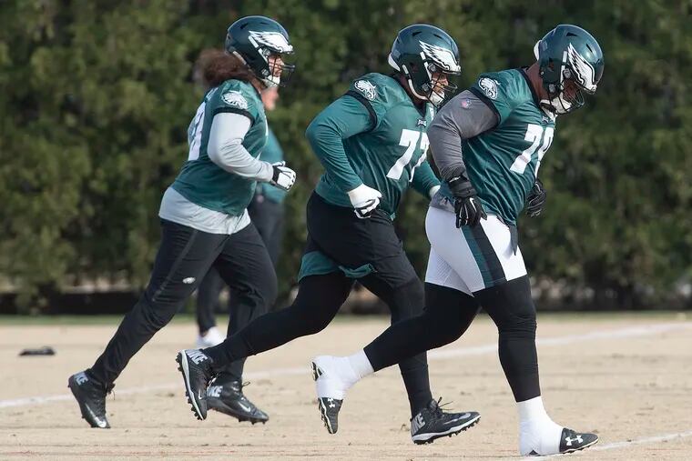Eagles, Isaac Seumalo, left, Andre Dillard, center, and Brandon Brooks, run during practice.