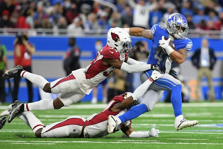 Detroit Lions running back Craig Reynolds getting caught by Arizona Cardinals free safeties Jalen Thompson, top, and Deionte Thompson during the second half of an NFL game Dec. 19, 2021, in Detroit.