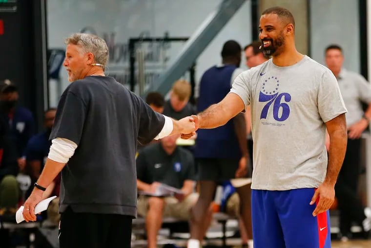 Philadelphia 76ers Head Coach Brett Brown shakes hands with assistant coach Ime Udoka during Brown's fifth annual coaches’ clinic at the Philadelphia 76ers Training Complex in September.