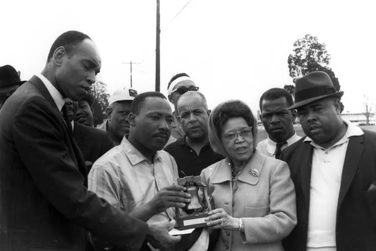 Sadie T.M. Alexander presents Martin Luther King Jr. with a liberty bell in 1965.