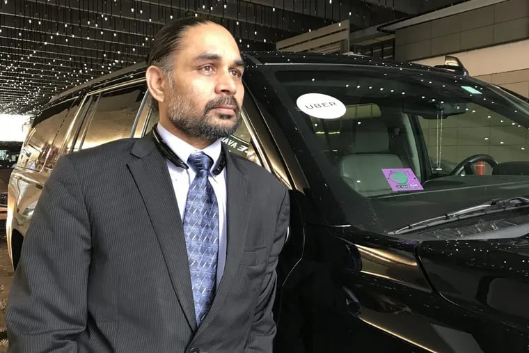 Virender Rana with the Chevrolet Suburban he drives for UberX and Uber Black