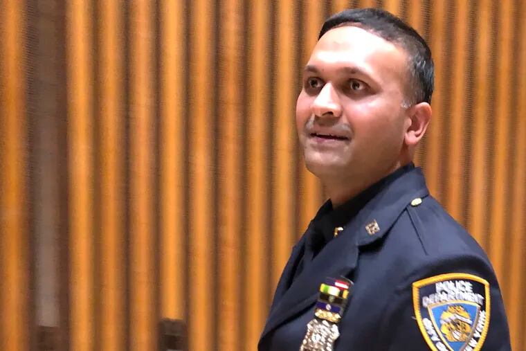 New York City police officer Syed Ali walks out of a briefing room at police headquarters, Thursday, Dec. 27, 2018, after speaking to reporters about his battle with three homeless men who came at him as he patrolled a Manhattan subway station on Sunday, Dec. 22. Ali has been widely praised for his response, which was caught on a video that has gone viral. Charges were brought against Ali's assailants after the video of the attack was viewed more than 4.75 million times on social media. (AP Photo/Michael R. Sisak)