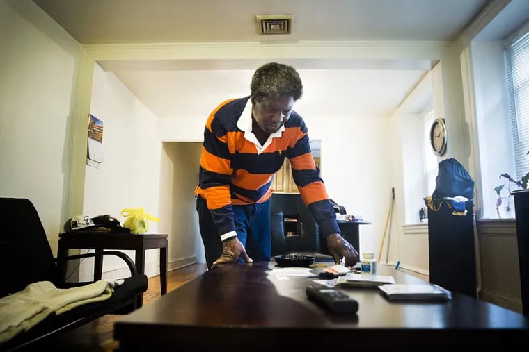 Emmett Paige, 61, and a client of Pathways to Housing, cleans his apartment in Germantown. Paige has been in the program for a year, and entered after years of homelessness and addiction in Kensington.