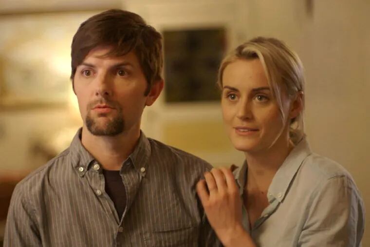 Adam Scott and Taylor Schilling play a married couple invited to a strangely friendly and seductive neighbor’s place. (JOHN GULESARIAN / The Orchard)