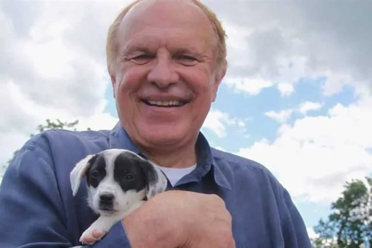 State Sen. Raymond Lesniak holds a rescue puppy at a “Paws Walk for a Cause” fundraiser in New Jersey. Lesniak is sponsoring legislation to toughen laws against pet stores selling dogs from unscrupulous commercial “puppy mills.”