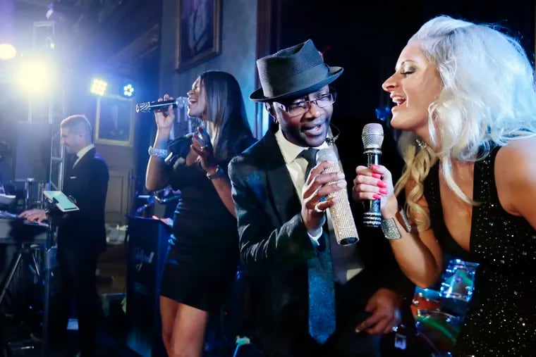 (L-R) Tesa Williams, Dondi Allen and Stephanie Williams on vocals as Philly wedding band Jellyroll rehearses for a wedding at the Union League in Phila., Pa. on August 17, 2019.